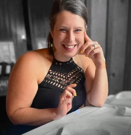 A. Sebesta smiling in a black dress